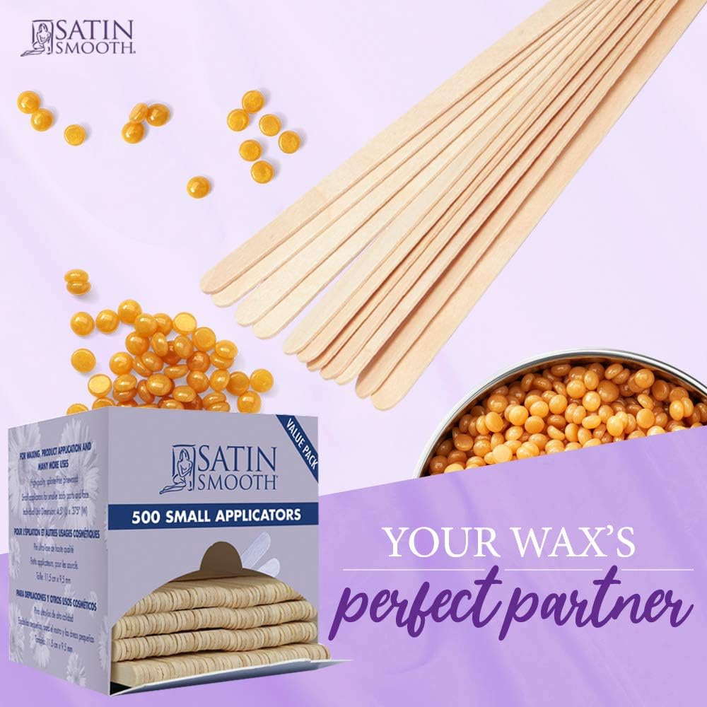 Wooden waxing sticks fanned out beside gold hard wax beads and the 500 applicator box