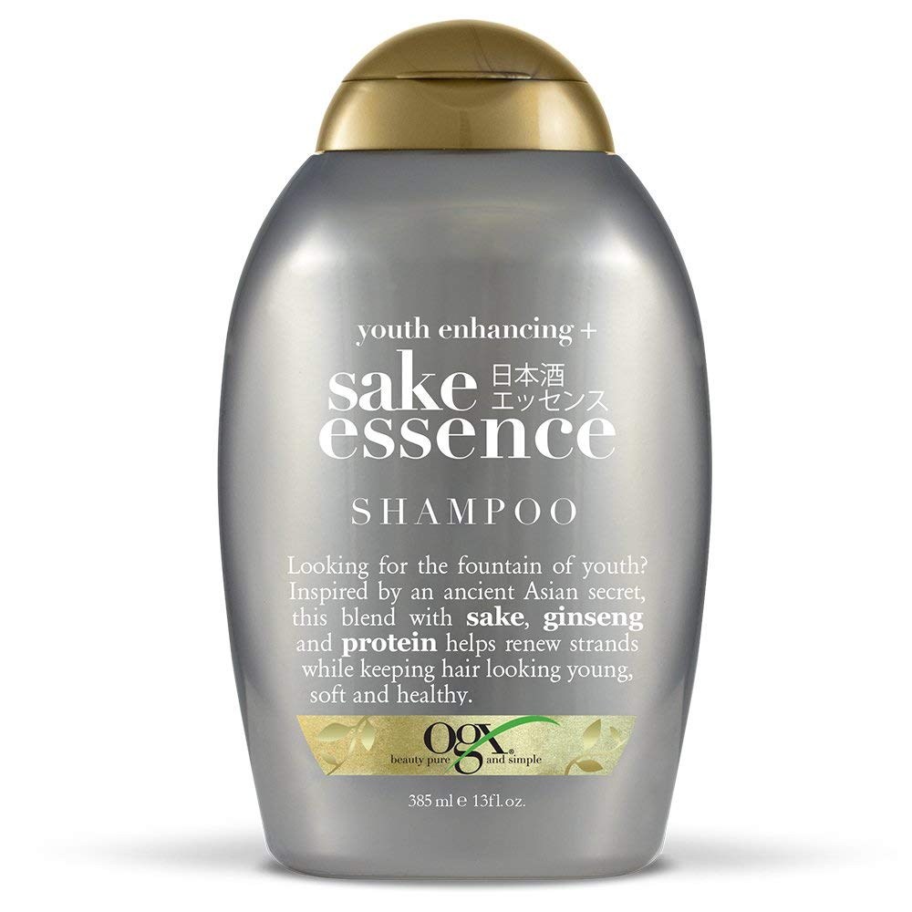 OGX Youth Enhancing Sake Essence shampoo in a silver 13 oz bottle with gold cap