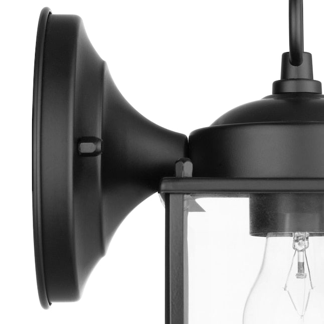 Close-up of the black wall plate and curved arm holding the lantern