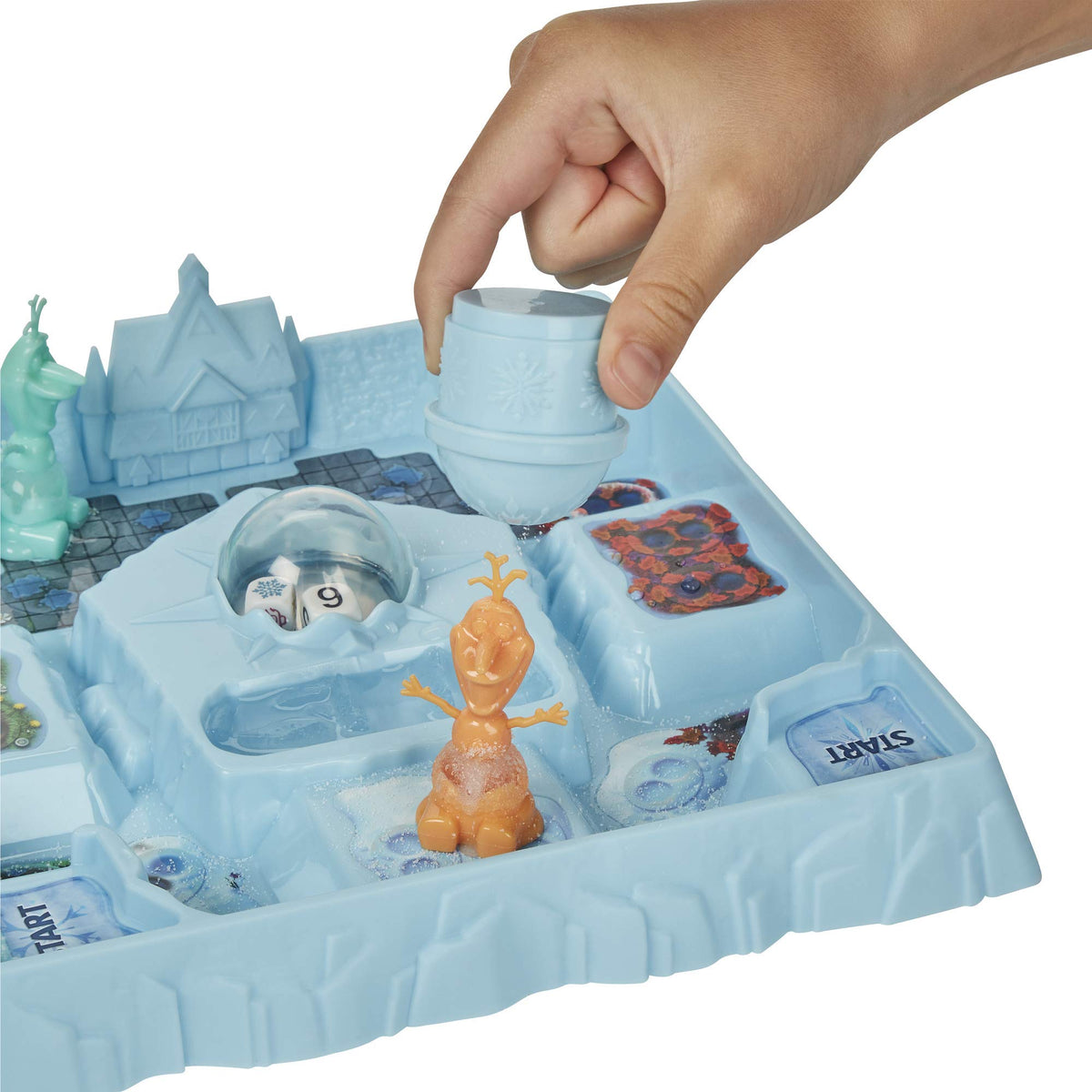 Hand shaking salt from a snowflake shaker over an orange Olaf pawn on the board