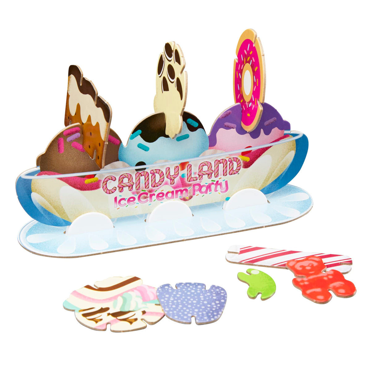 Sundae stand with a few toppings added and a gummy bear and candy stick beside it