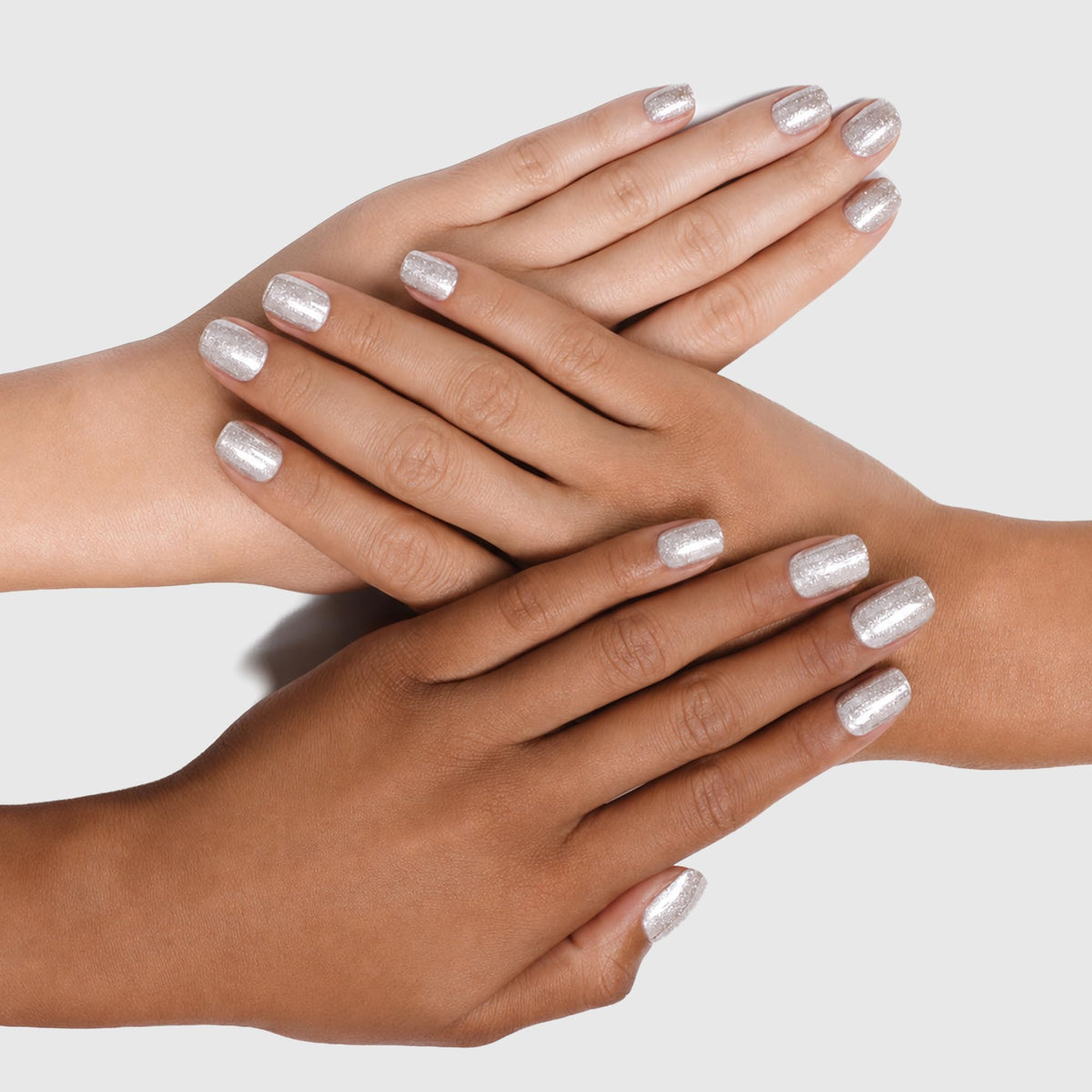 Three hands in different skin tones with sparkly silver painted nails