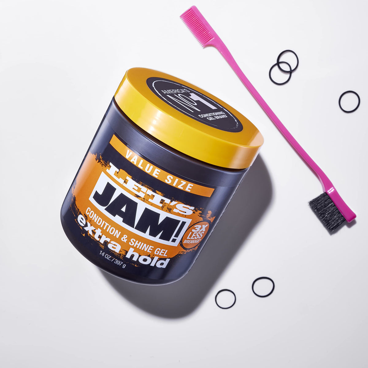 Gel jar lying on its side with a pink edge brush and black hair elastics