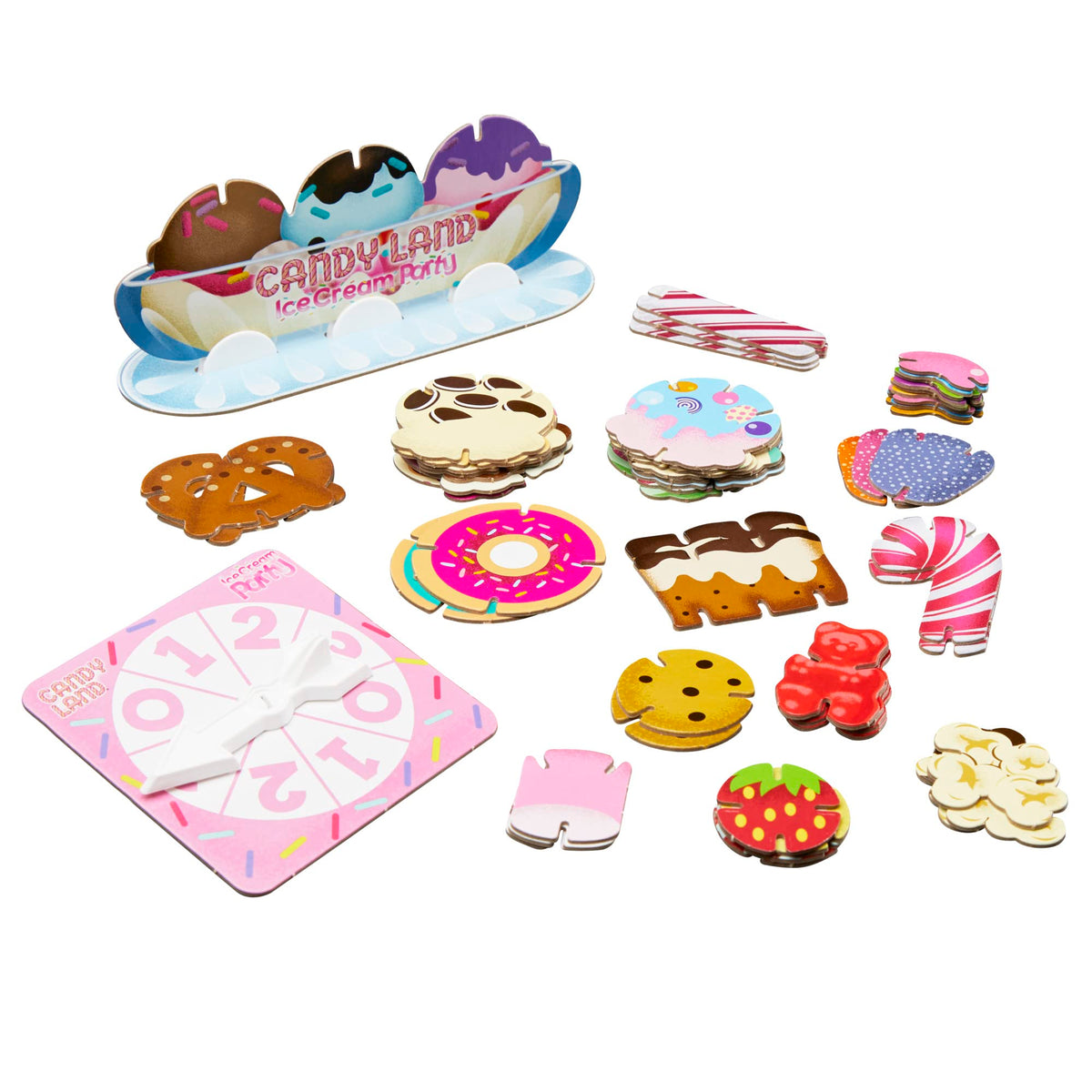 All game pieces laid out: sundae stand, spinner and stacks of cardboard treats