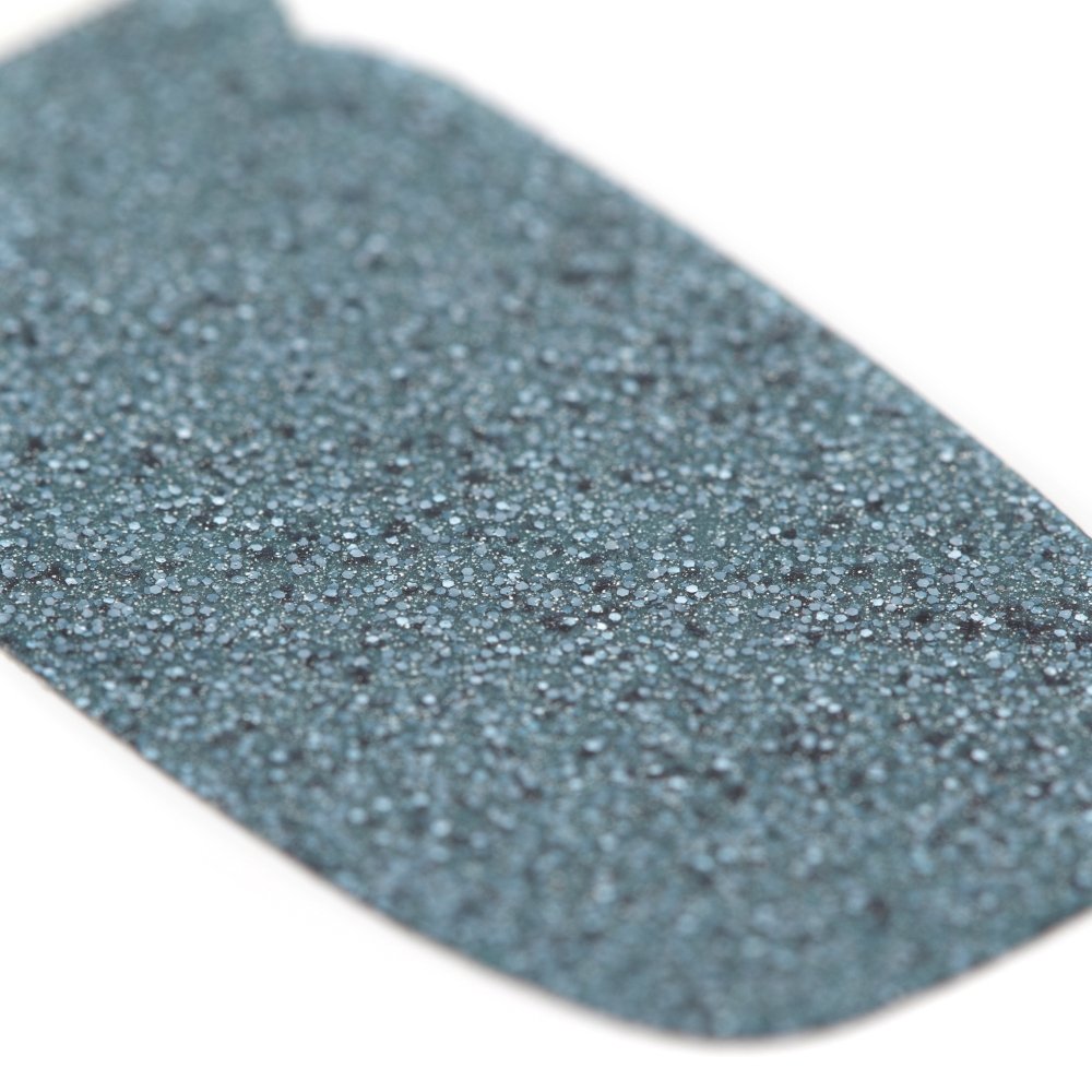Close-up of a slate blue glitter textured nail polish strip