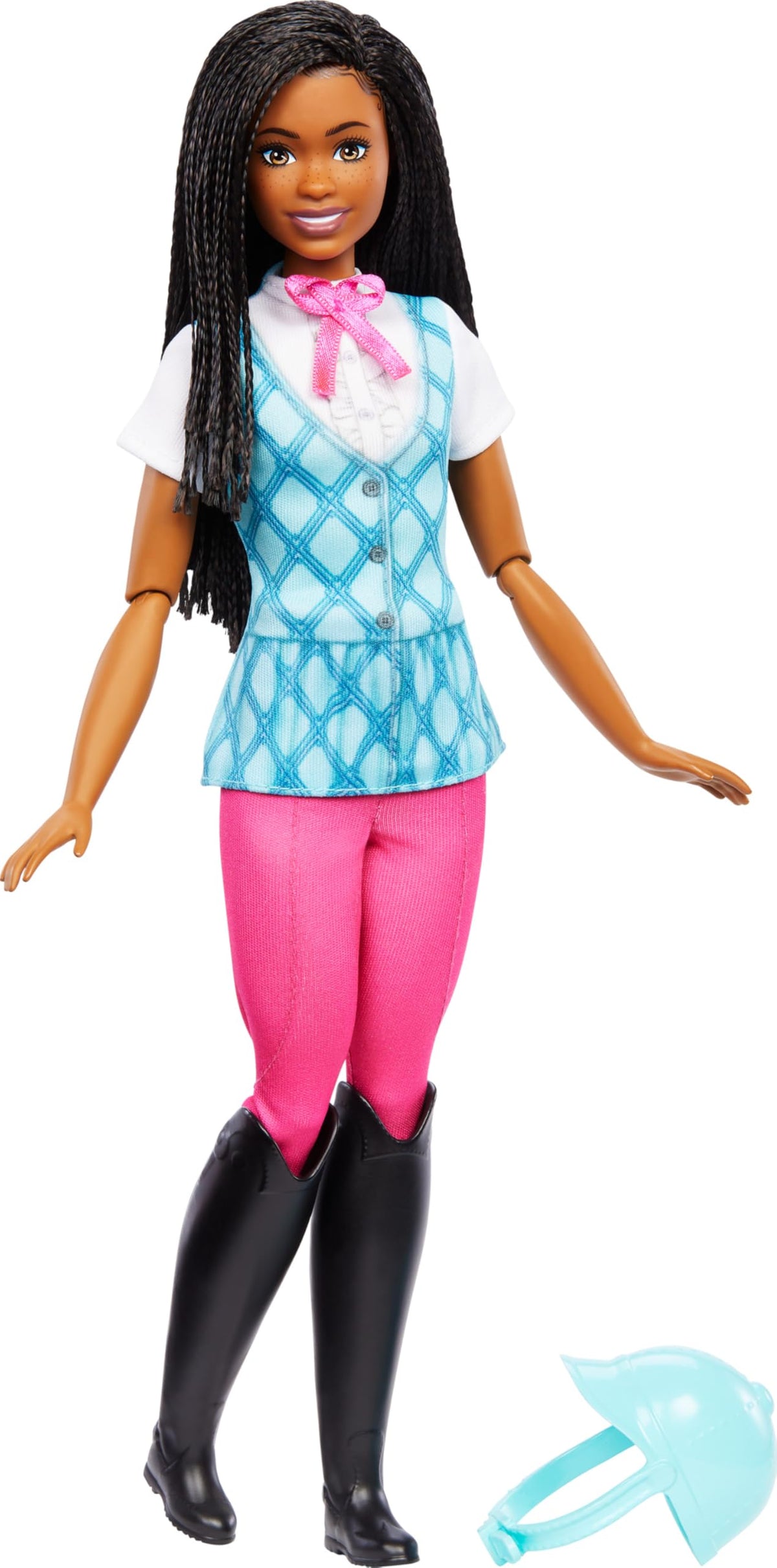 Barbie Brooklyn doll standing in riding outfit with her light blue helmet on the ground beside her