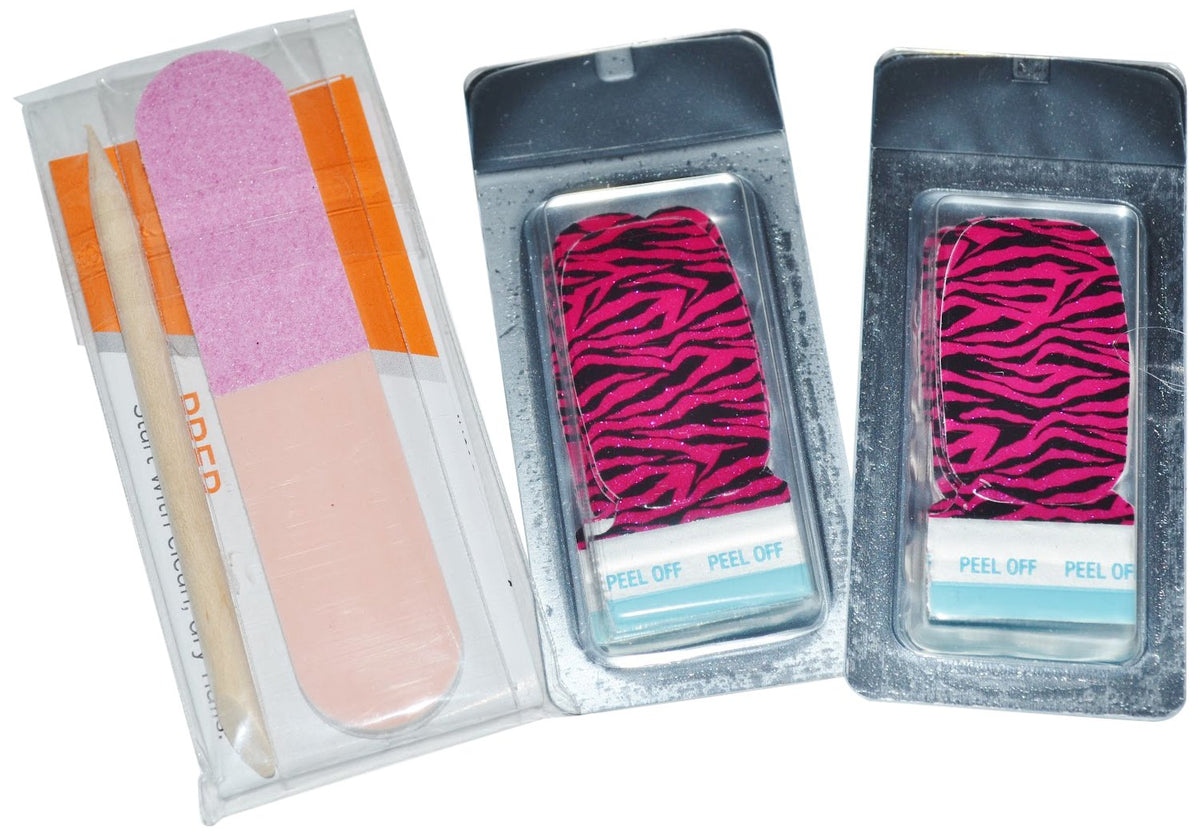 Two packs of pink and black zebra nail strips beside a cuticle stick and buffer