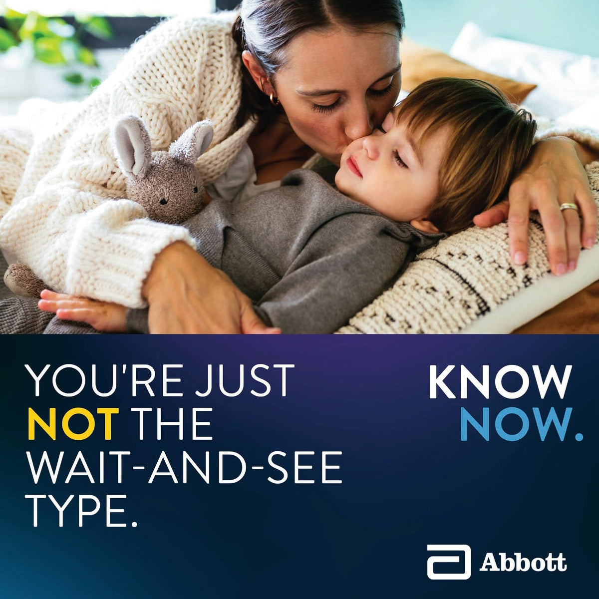 Mother kissing a sleepy child holding a plush bunny, Know Now caption