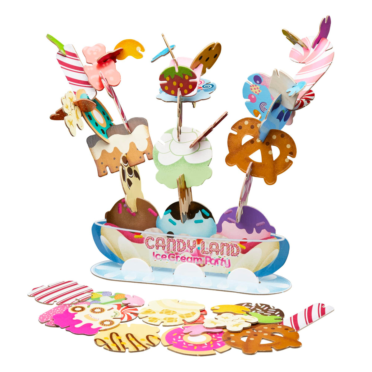 Sundae bowl stacked with cardboard treats, more toppings spread in front