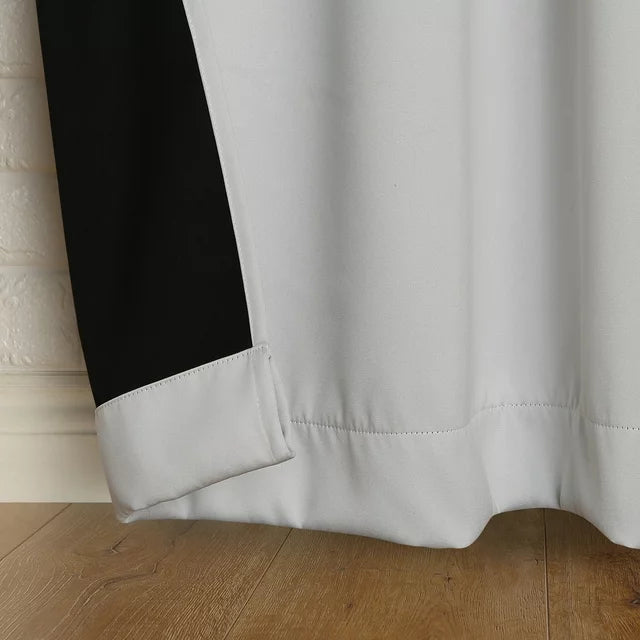 Folded-back hem showing the black blackout backing behind pearl fabric