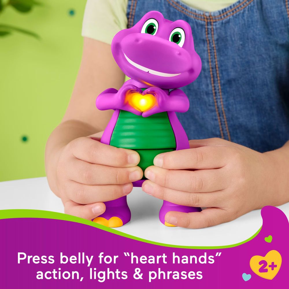 Child holding Barney as he makes heart hands with his heart glowing