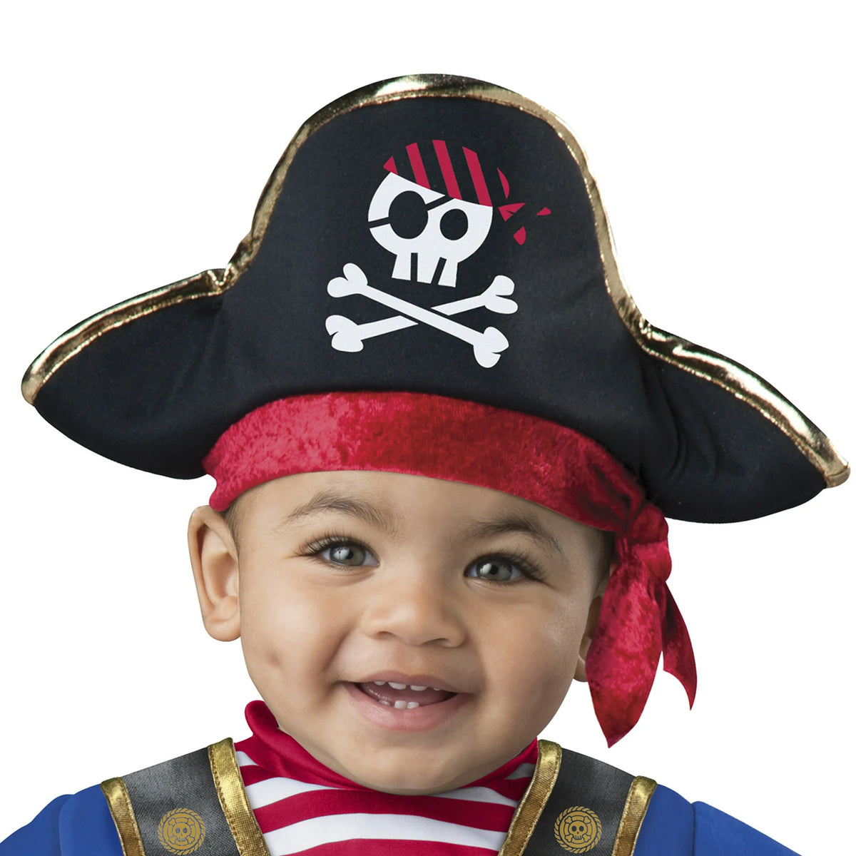 Close-up of a smiling baby in a black pirate hat with skull and crossbones and red bandana
