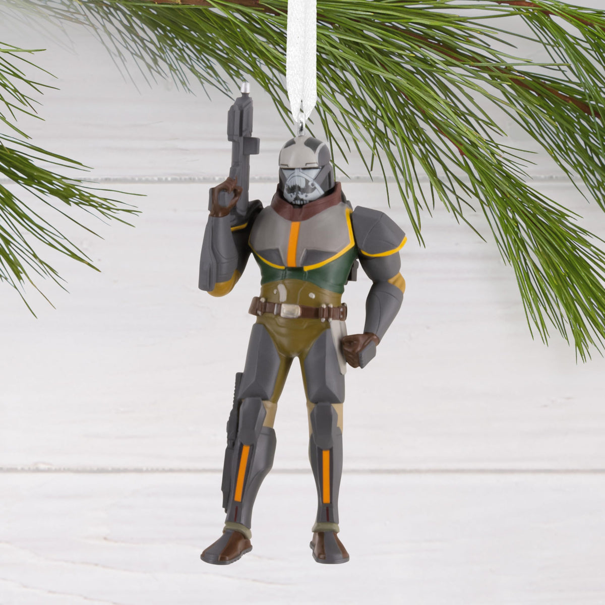 Bulky armoured soldier ornament hanging from a pine branch