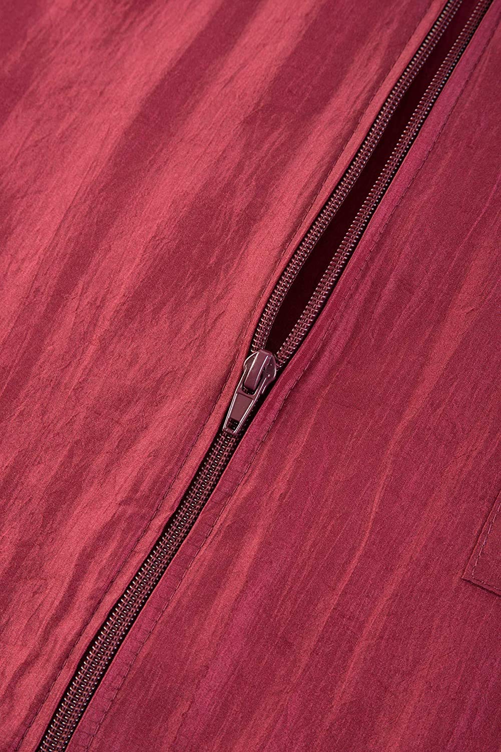 Close-up of the partly open burgundy zip on crinkled nylon fabric