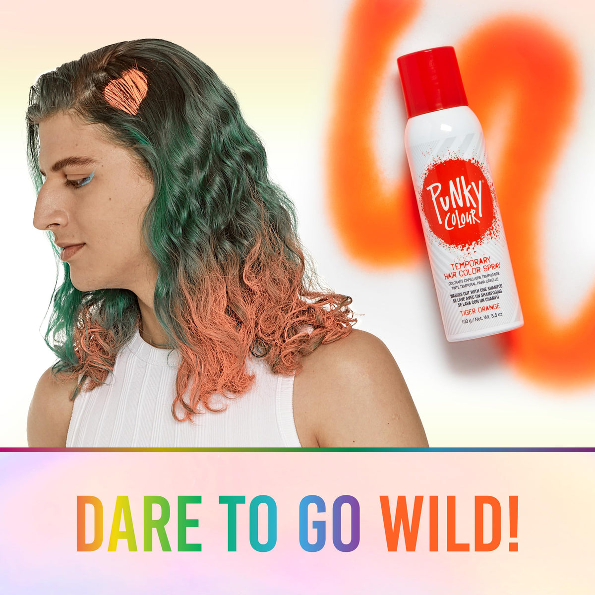Person with green wavy hair, orange tips and an orange heart sprayed near the parting