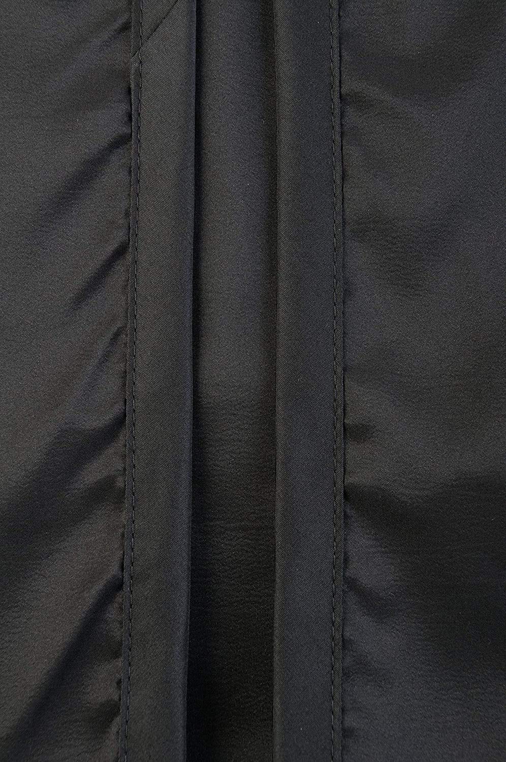 Close-up of the stitched front overlap on shiny black nylon