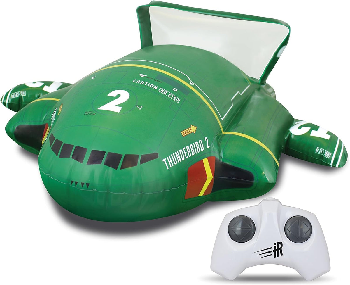 Inflatable green Thunderbird 2 craft beside its white remote