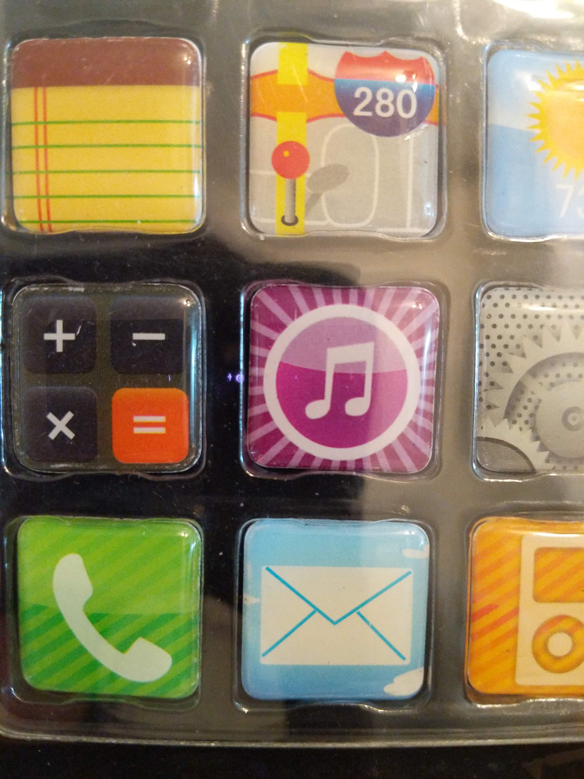 Close-up of the notepad, map, calculator, music, phone and mail icon magnets