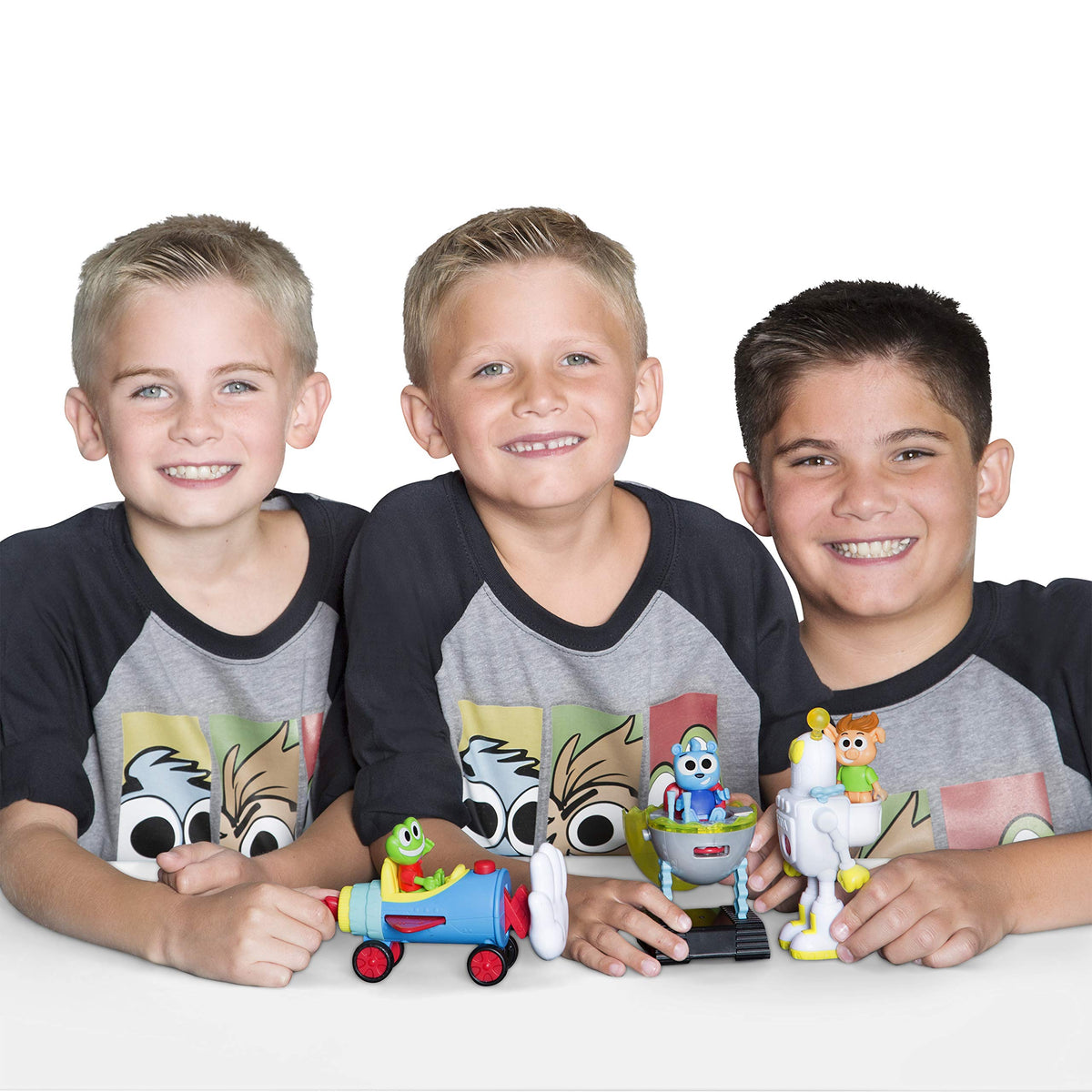 Three smiling boys holding a frog rocket car, egg vehicle and robot toy