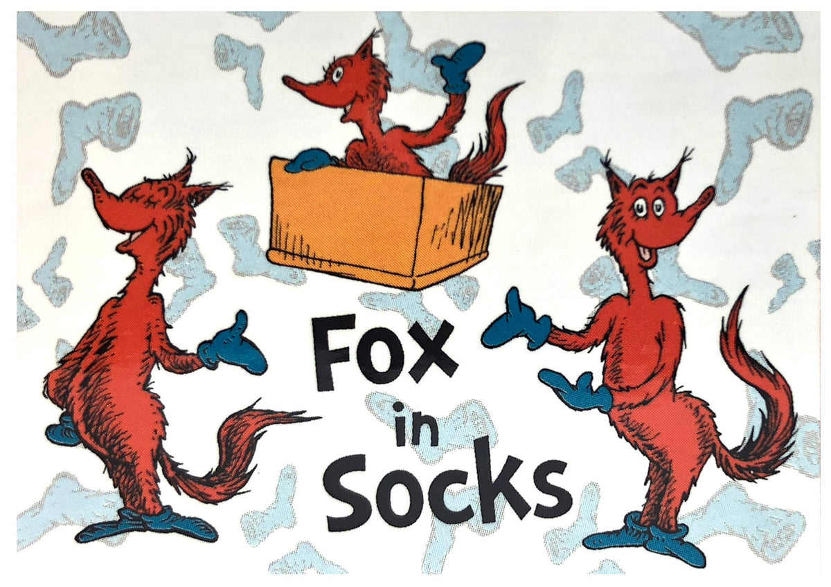 Finished puzzle scene of three red foxes in blue socks around a box with Fox in Socks lettering