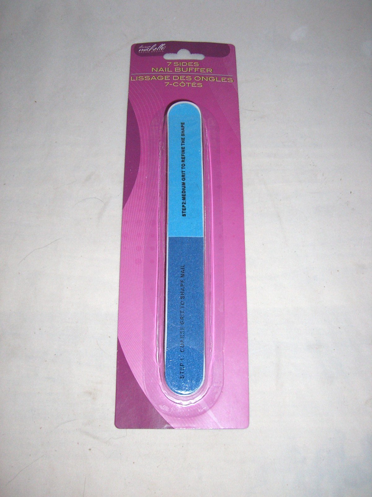 Donna Michelle 7-sided blue nail buffer on a pink and purple card