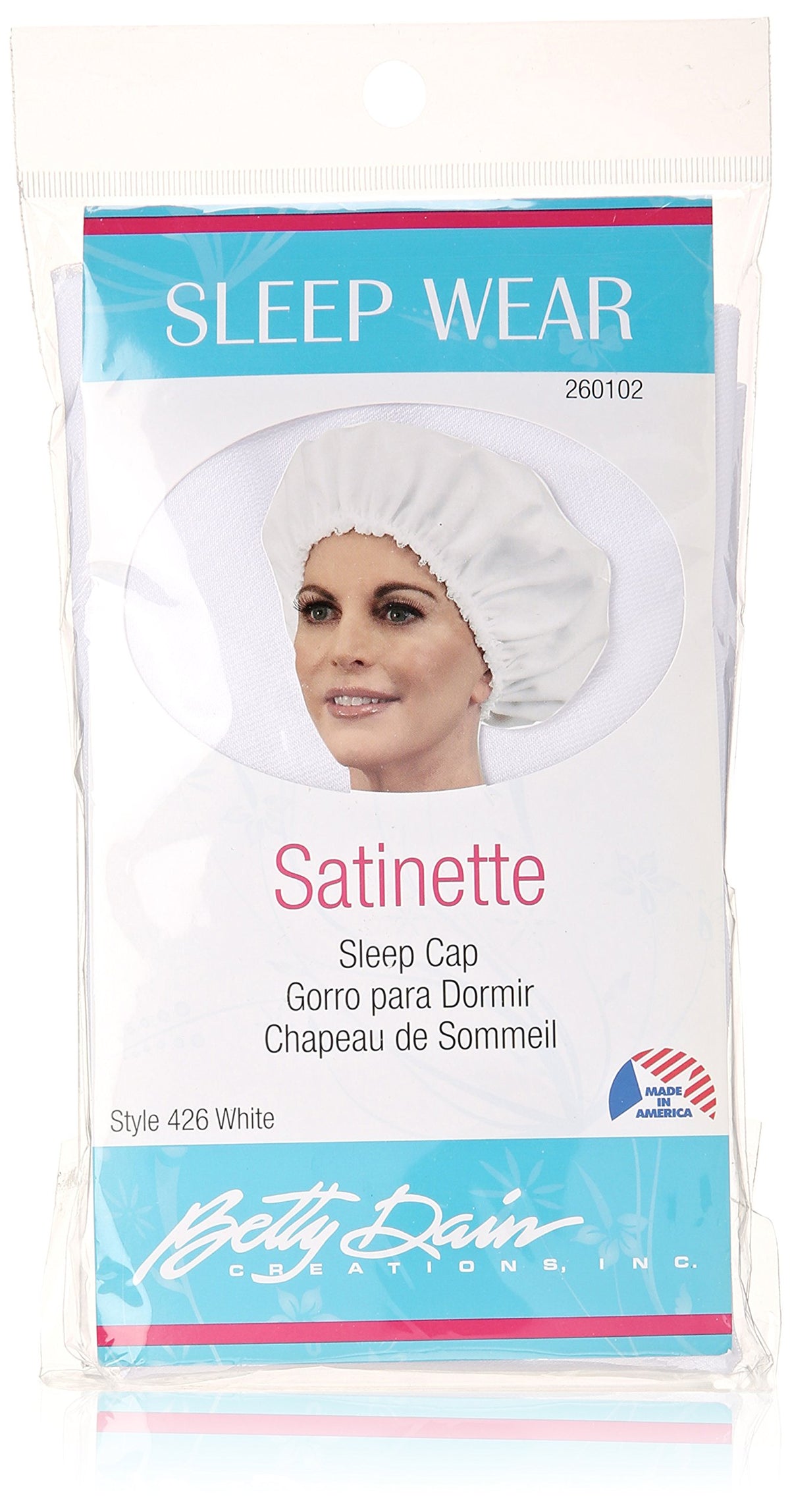 Packaged white satinette sleep cap style 426 with a woman wearing it on the card
