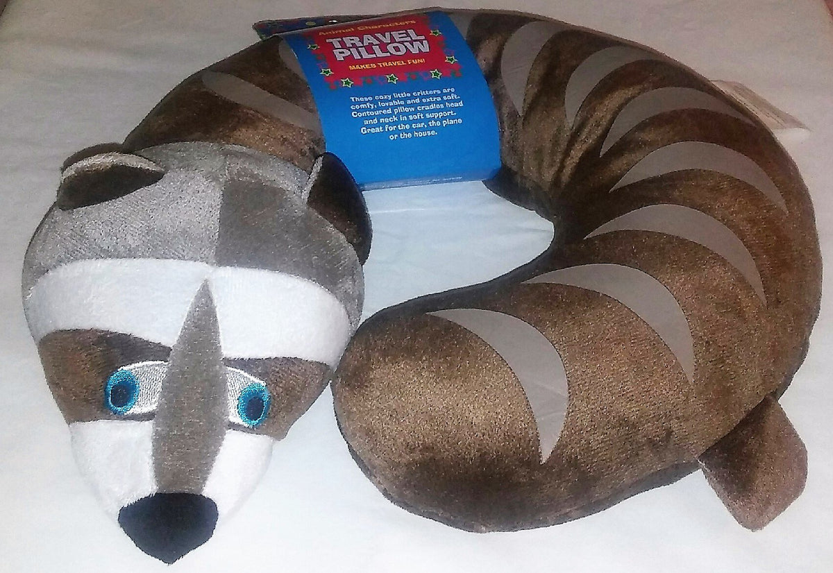 Brown and grey raccoon neck pillow with blue eyes and a striped tail, with hang tag