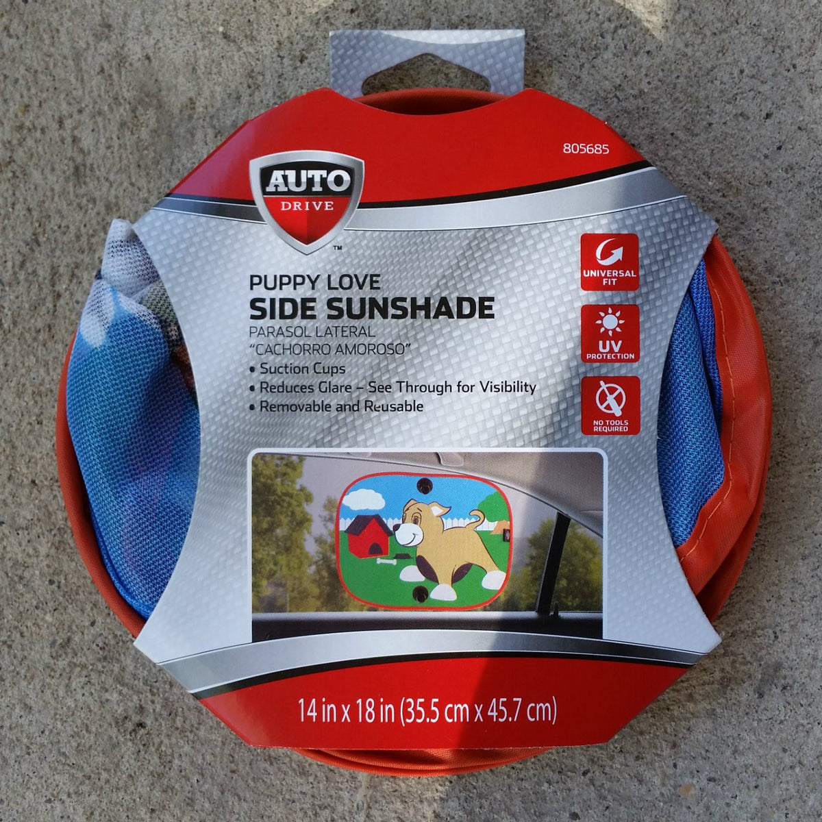 Round red and silver pack holding a mesh window sunshade with a cartoon puppy