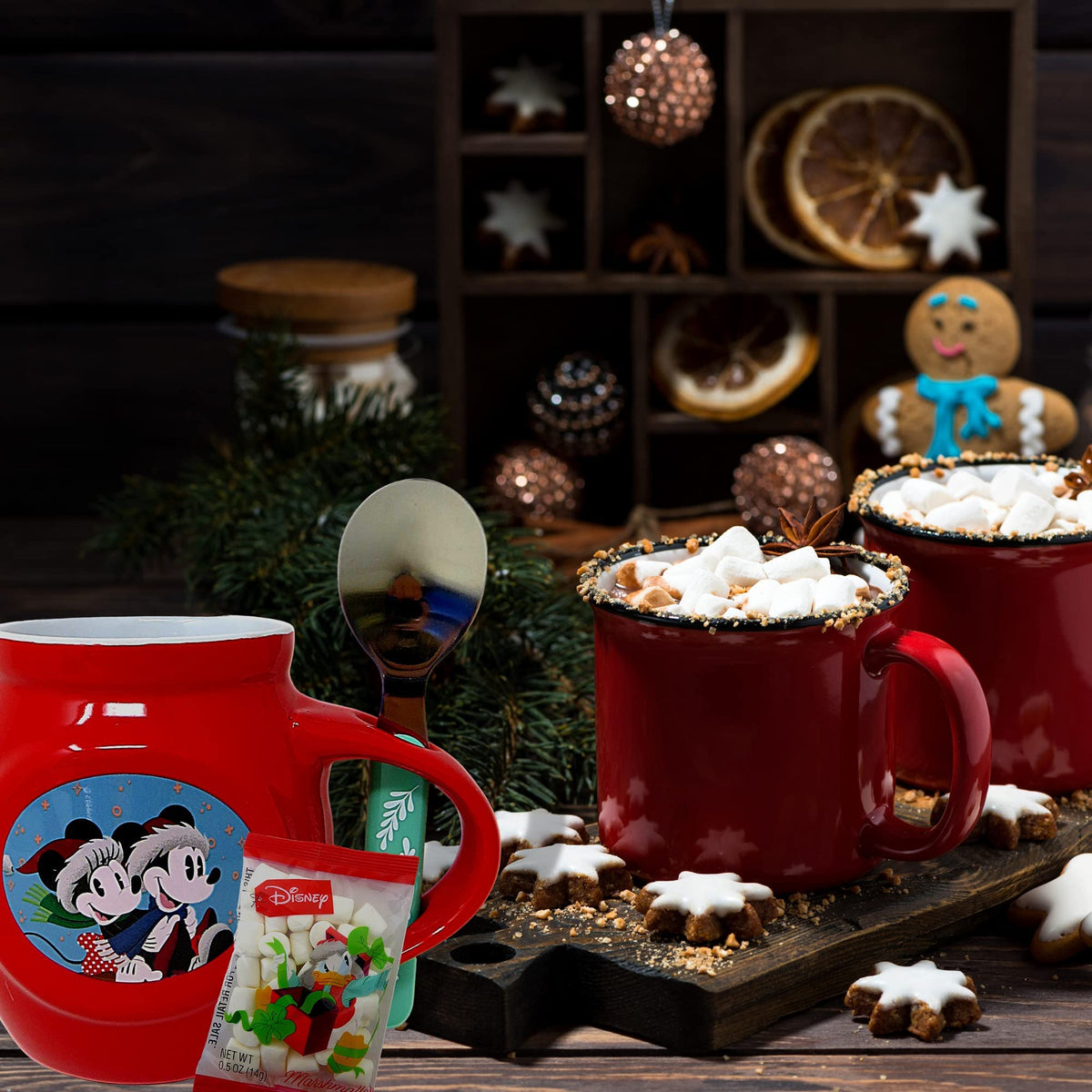 Mickey holiday mug and marshmallows beside mugs of cocoa and star cookies
