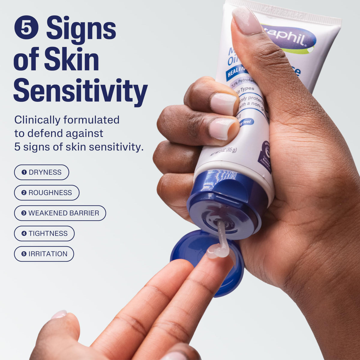 Hand squeezing clear Cetaphil ointment from a tube onto a fingertip