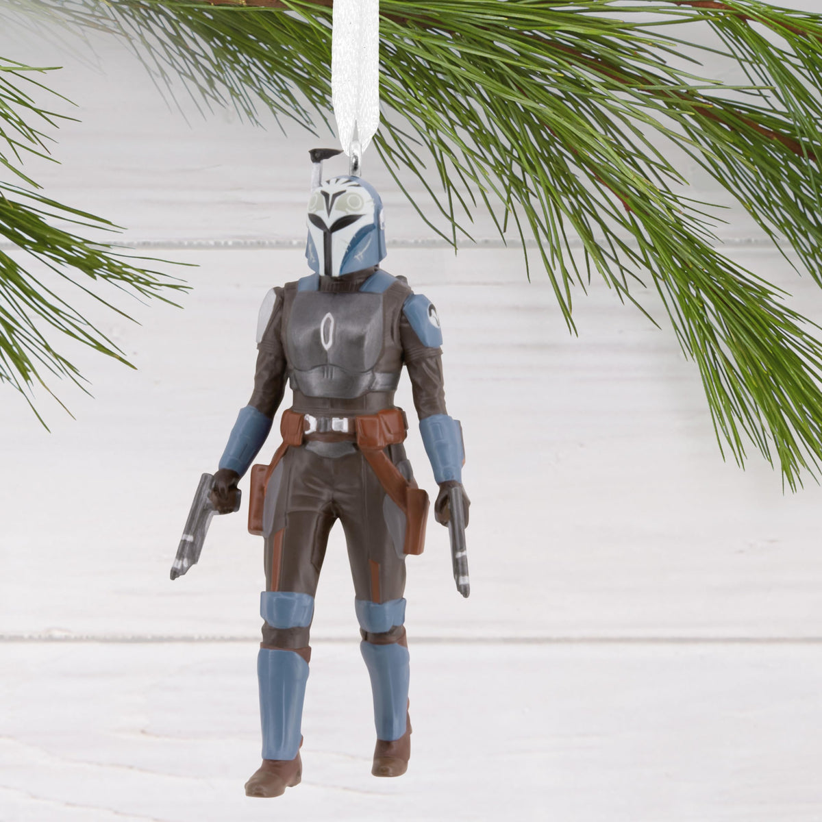 Armoured warrior ornament hanging from a pine branch
