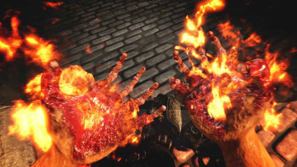 Game screenshot of first-person hands bursting into flames over a cobblestone street