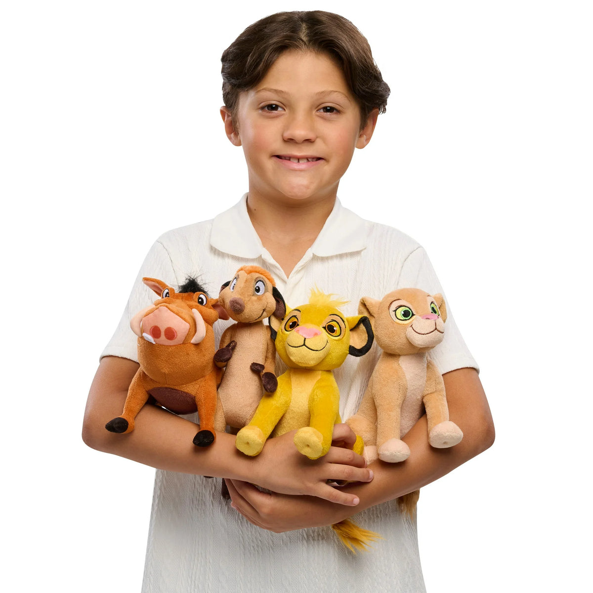 Smiling child holding all four lion cub, meerkat and warthog plush toys