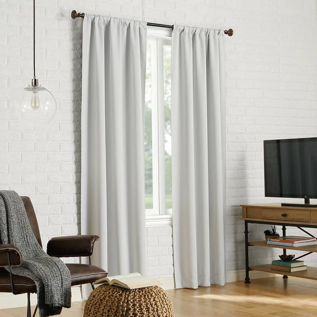 Pearl white panels on a window in a living room with a leather chair