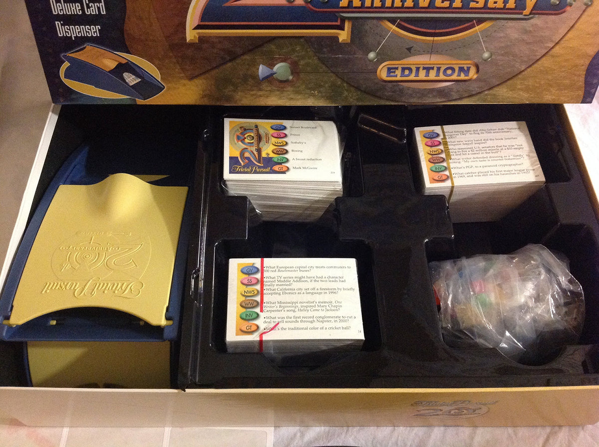Open box with the yellow and blue card dispenser, card stacks and bagged wedges in the tray