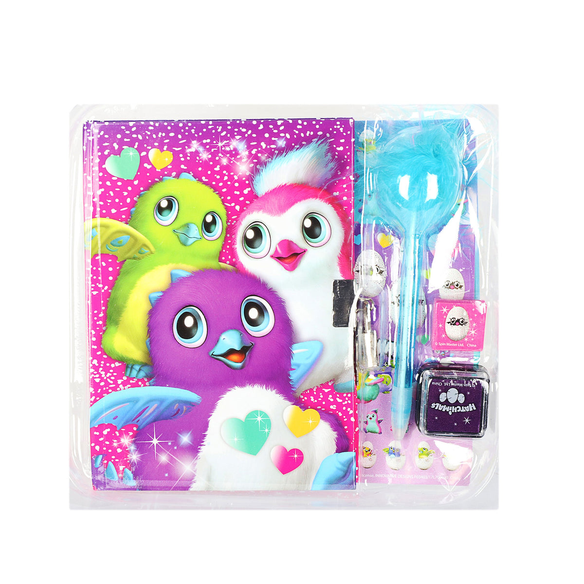 Diary with green, white and purple furry creature cover beside a blue feather pen and ink pad