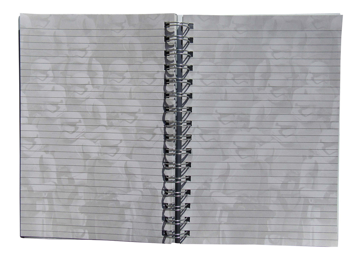 Open spiral notebook showing ruled pages with faint stormtrooper print