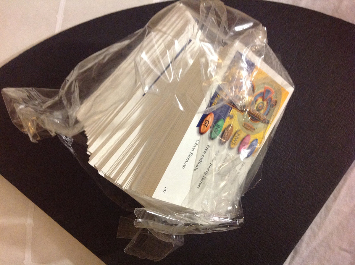 Stack of question cards still sealed in clear plastic wrap