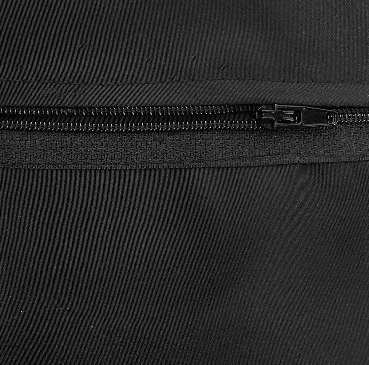 Close-up of the black zipper at the bottom of an apron pocket