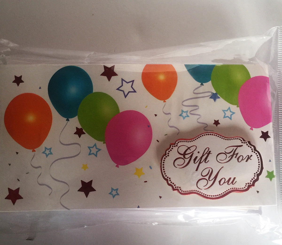 One balloon print money holder with a Gift For You tag, shown through the bag