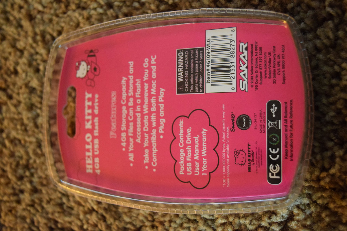 Back of the pink Hello Kitty USB drive card listing features and package contents