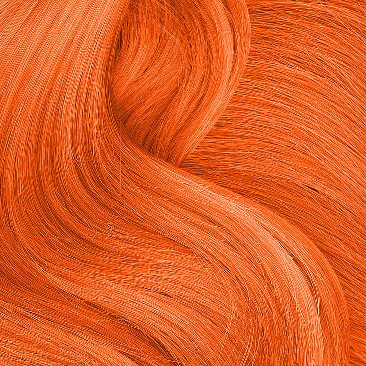 Close-up of wavy hair coloured bright tiger orange