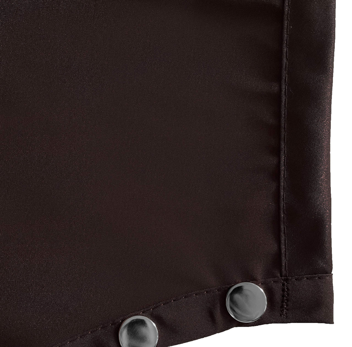 Close-up of two silver snaps on the brown apron neck strap