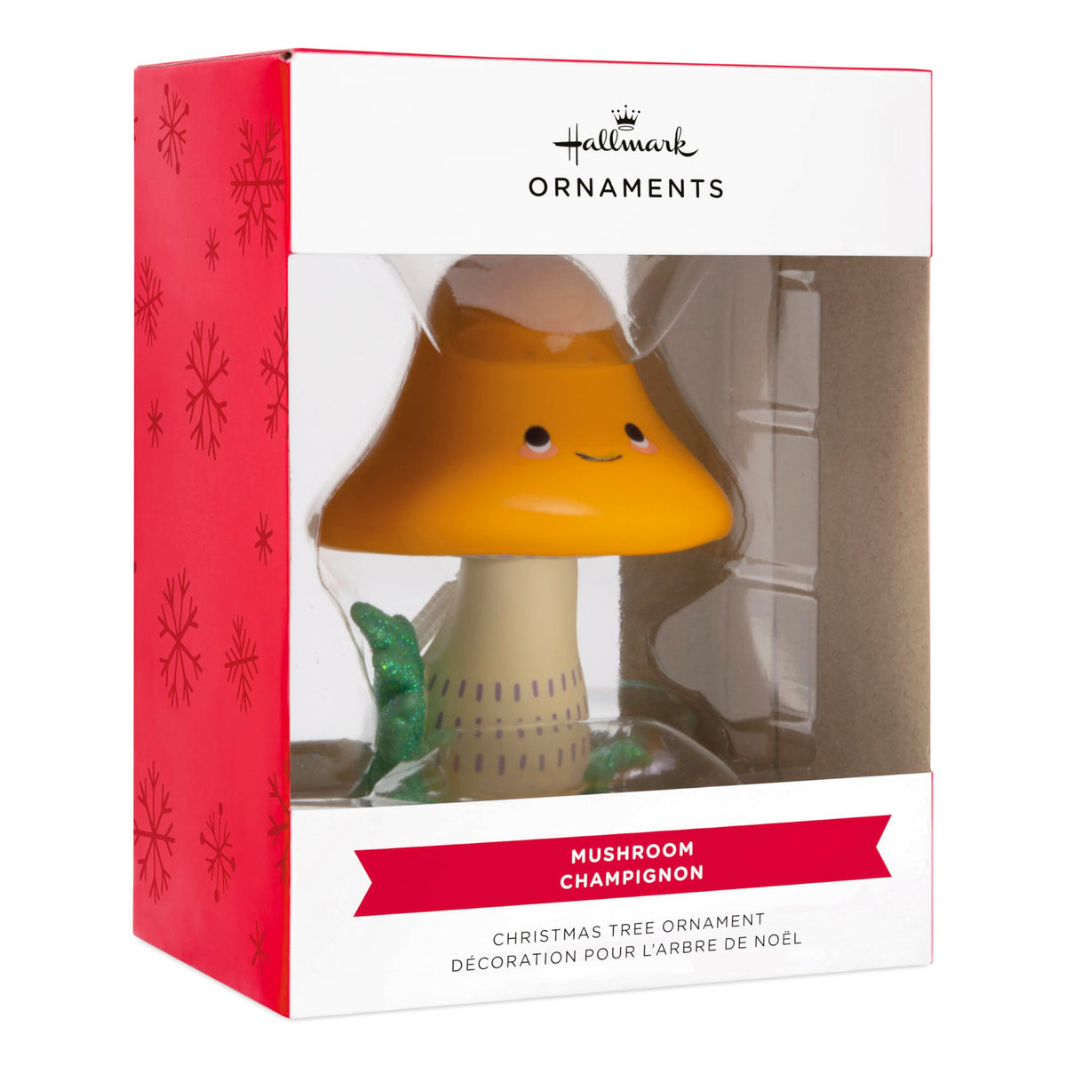 Smiling mushroom ornament in its red and white snowflake window box