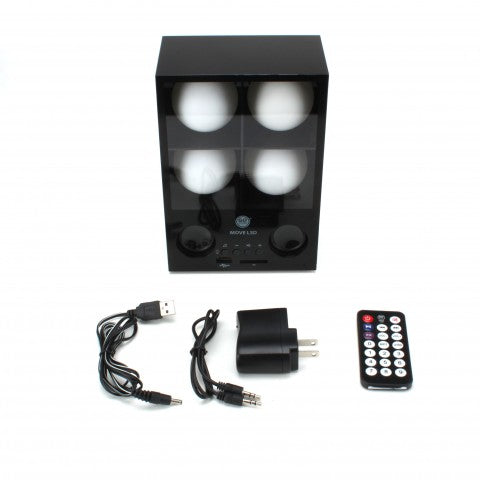 Speaker with its USB cable, audio cable, wall adapter and remote laid out below