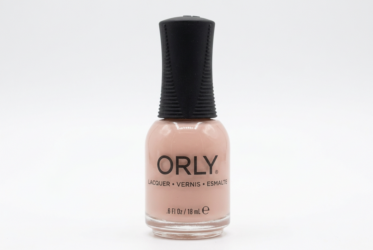 ORLY Pink Slip nail polish bottle in a nude pink-beige creme with black ribbed cap, on white