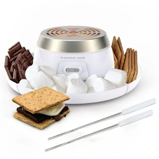 White electric s'mores maker with a steel heating top, tray of marshmallows, chocolate and crackers, two skewers