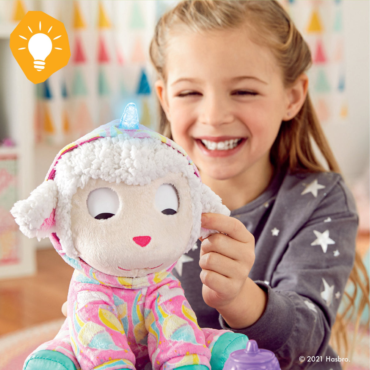 Smiling girl touching the ear of the lamb plush as its eyes close in sleep mode
