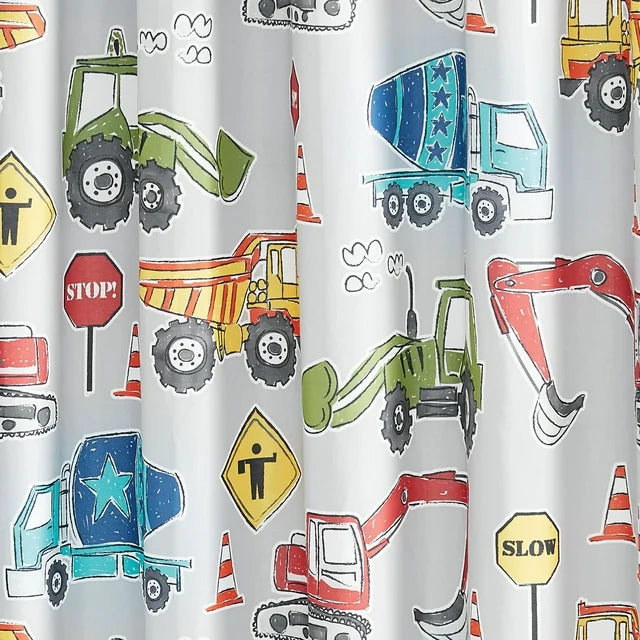 Top of the construction print curtain hanging from rings on a rod