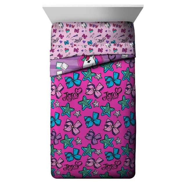 Reverse side of the comforter: pink with teal bows and green stars